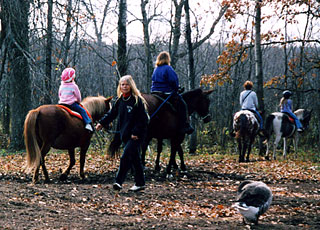 Children on a trail ride at Pine River Stable.
